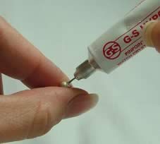 Adhesive being squeezed into a bead end